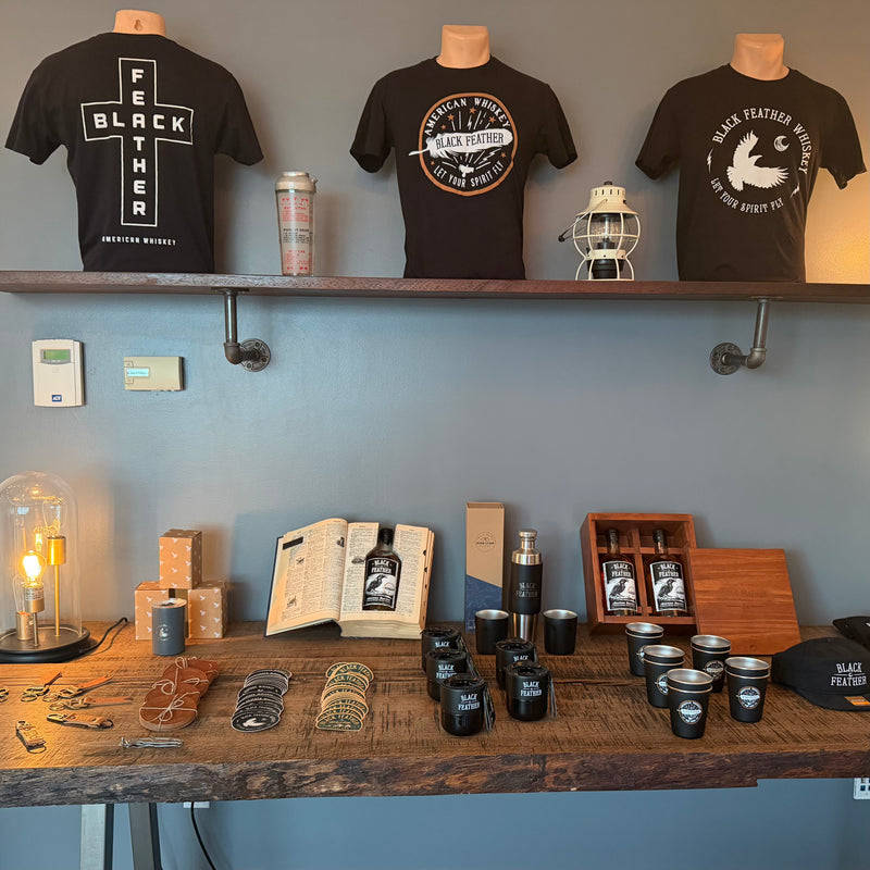 Black Feather merch and whiskey on display at the SLC bottle shop